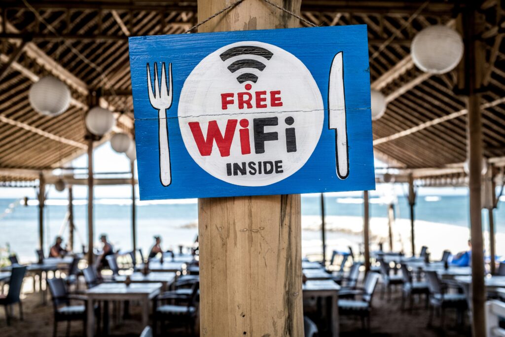 person-using-laptop-in-cafe-on-free-wifi`
