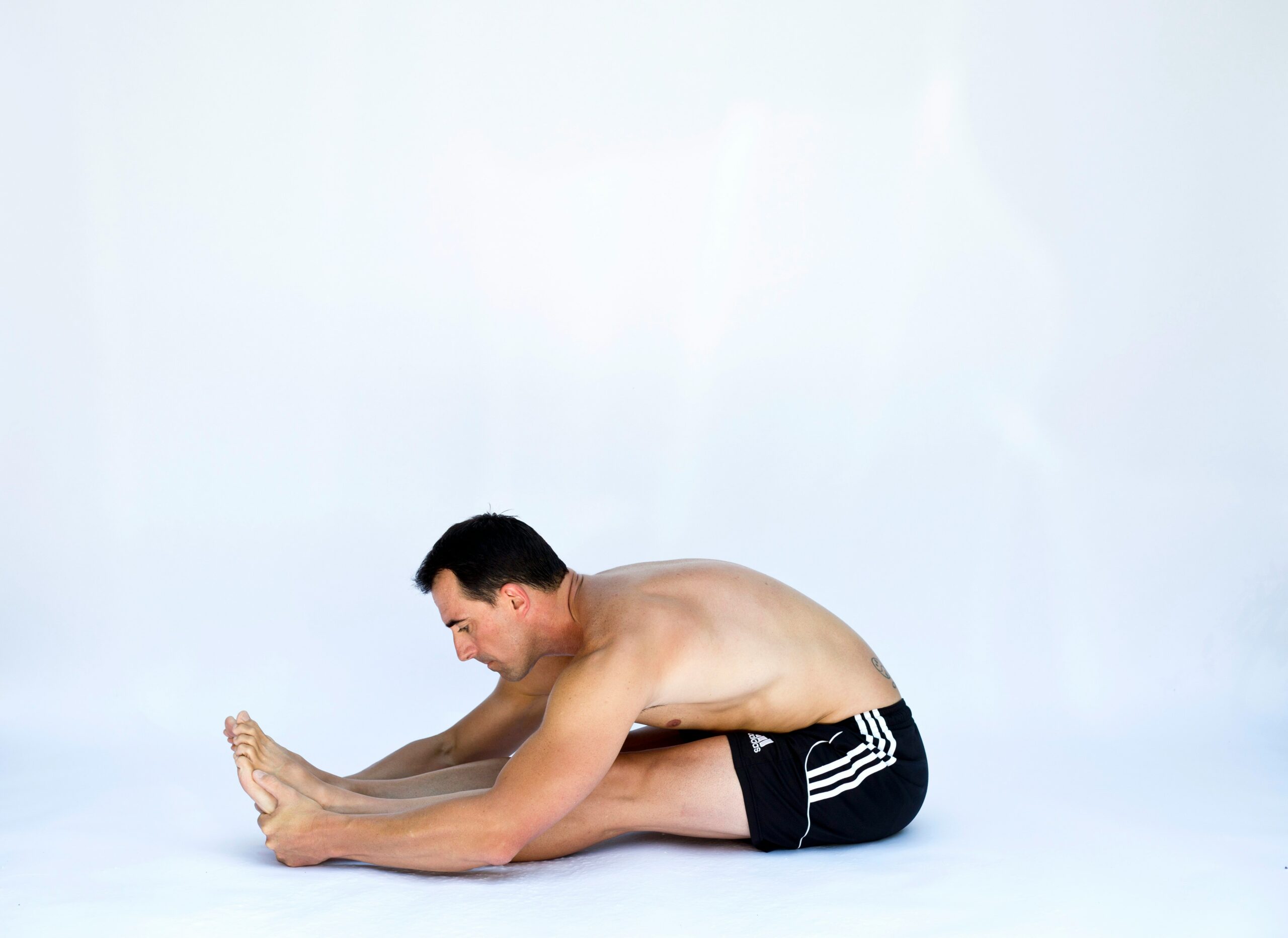 Yoga practitioner in Head-to-Knee Pose stretching hamstrings