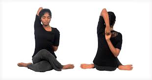 Yoga practitioner in Cow Face Pose stretching triceps and shoulders.