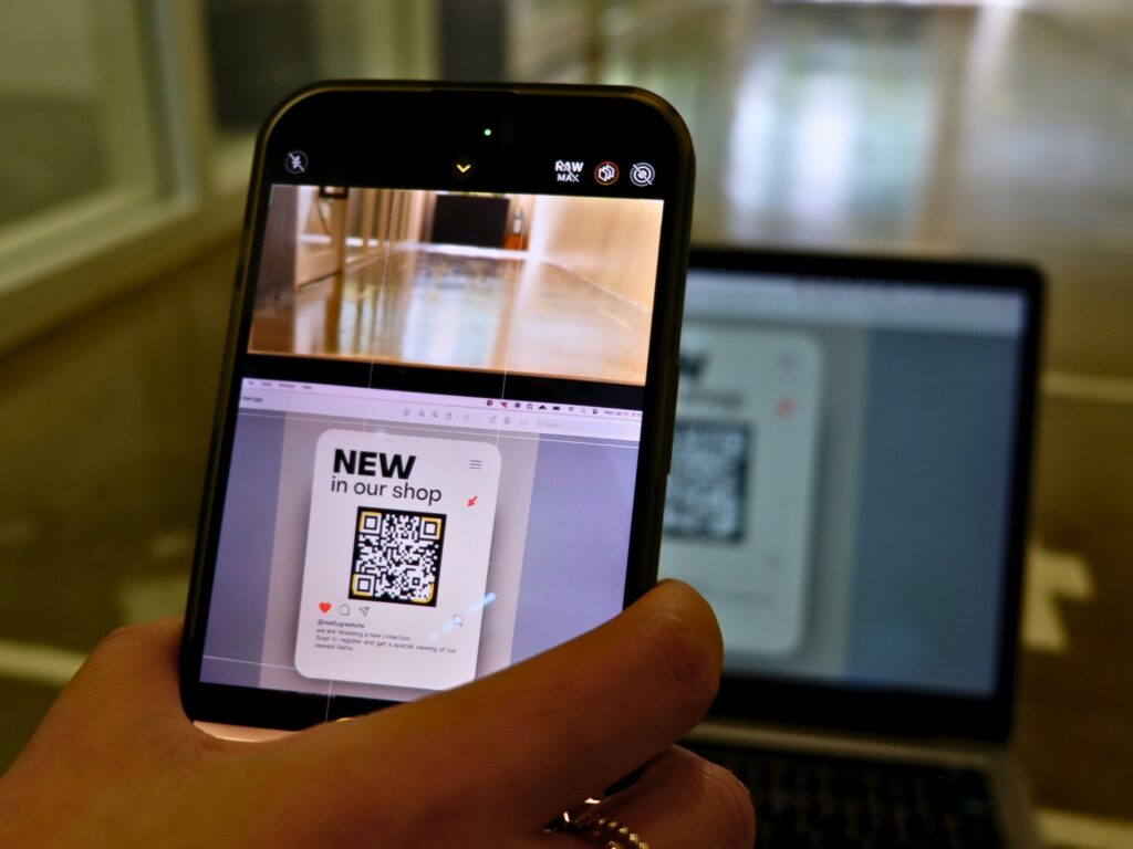 Close-up of a fake QR code sticker pasted over an official restaurant menu code.