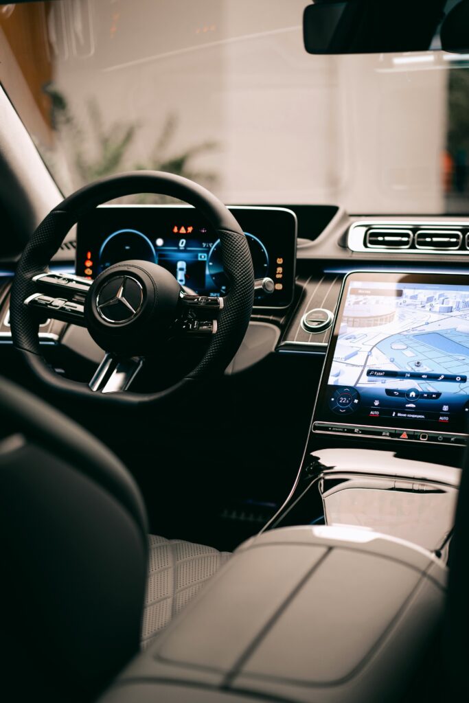 Close-up of car infotainment screen syncing with a smartphone.